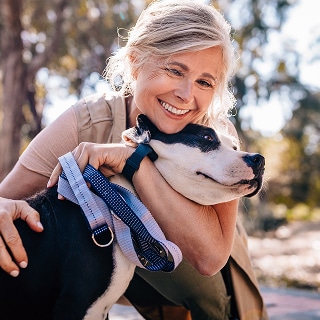photo of woman and dog the benefits of touch for longevity
